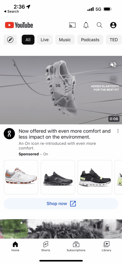 A YouTube ad. The video thumbnail shows a single gray athletic shoe on a gray background. Below the video there is a row of product photos showing different athletic shoes. There is a call-to-action button that reads: Shop now.