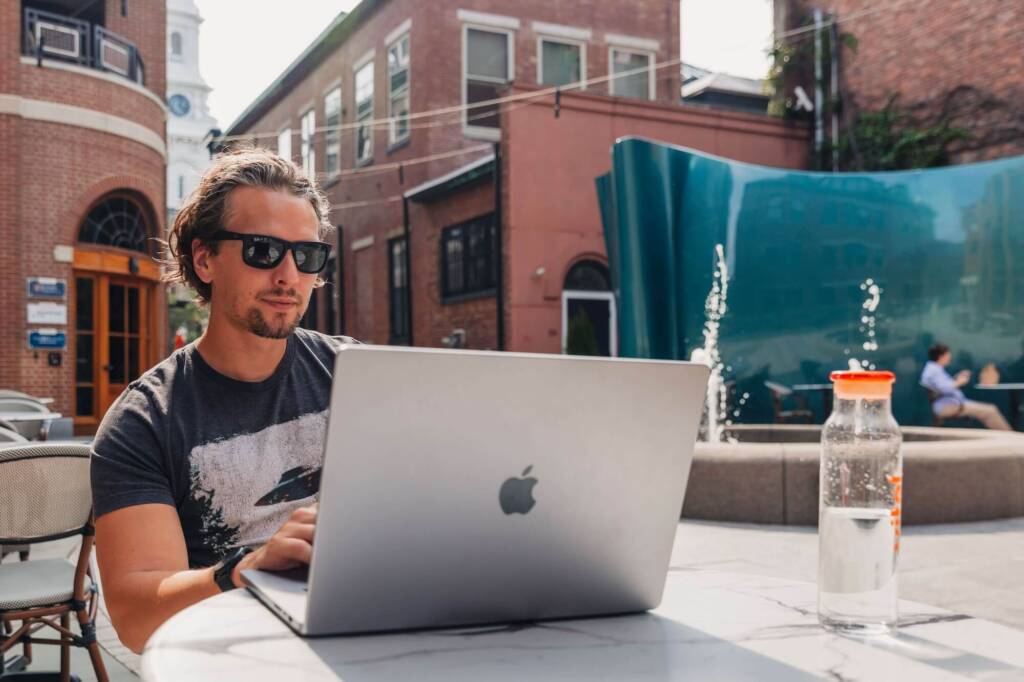 Jesse-working-remotely-outside-at-a-table