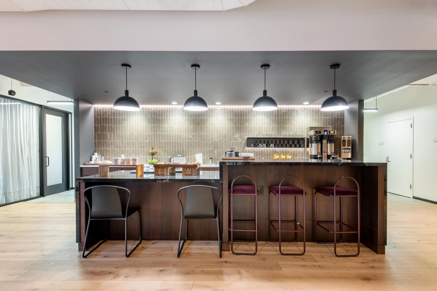 Digital Marketing Agency - Boston, MA 3 A sleek modern office featuring a bar area with stylish chairs for casual meetings and relaxation.