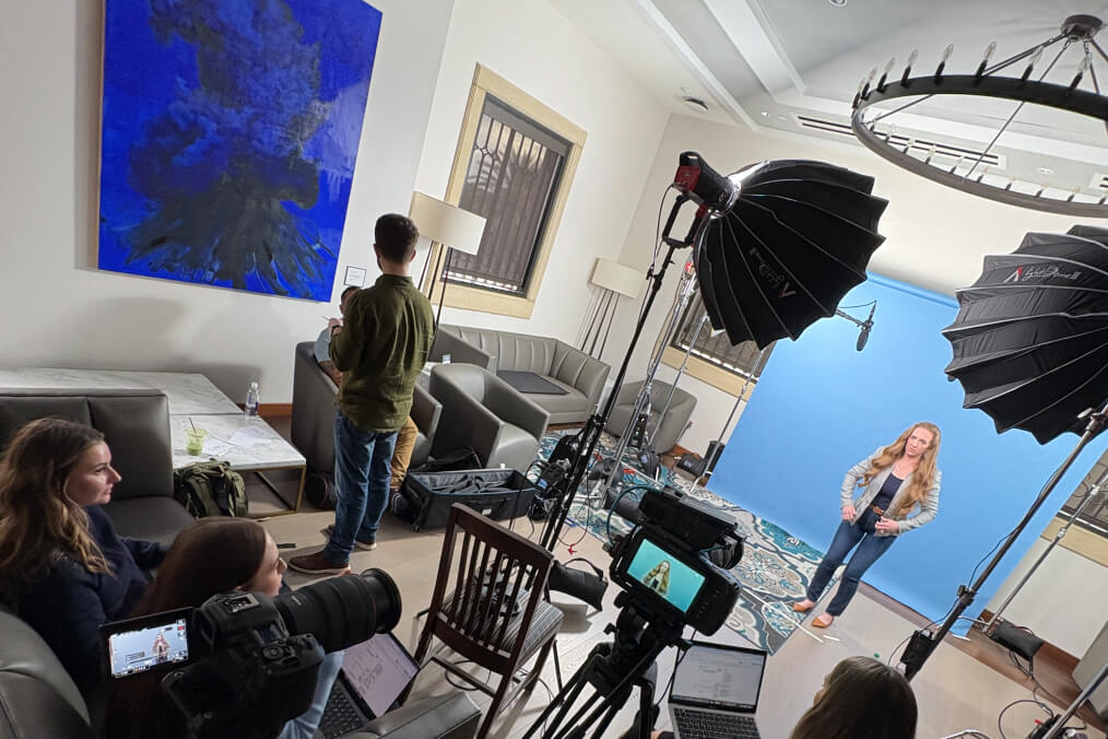 People in a room preparing for a video shoot